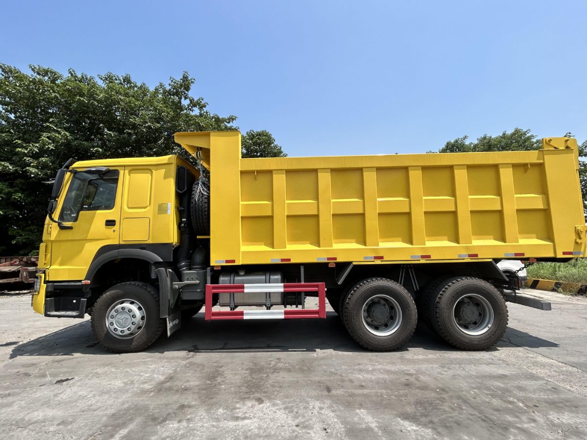 Yellow 6x4 tipper truck, side view